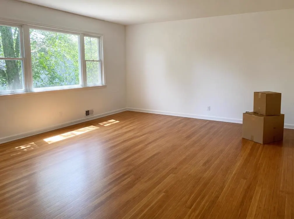 Empty room with freshly cleaned hardwood floors after a move-out clean